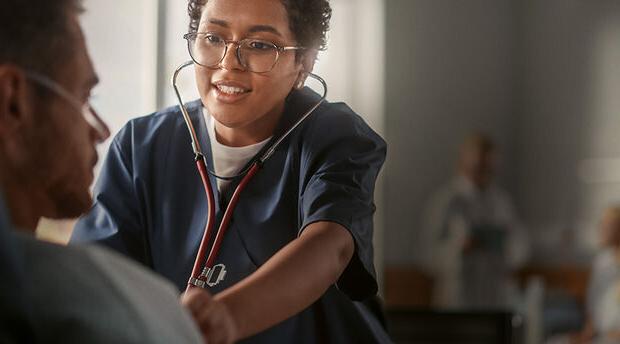 Healthcare professional uses stethoscope to listen to heartbeat